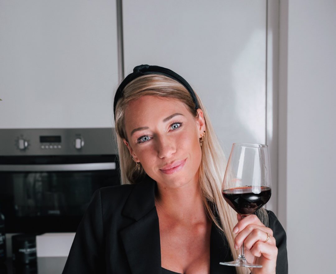 Demi with a glass of red wine